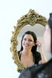 Woman putting on mascara