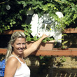 Woman reaching out to take a flower