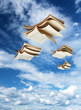 Photo: Four open books flying above Four open books flying above