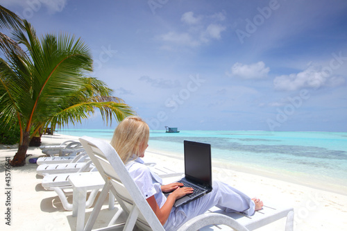 Photo: tropical business woman with laptop tropical business woman with laptop