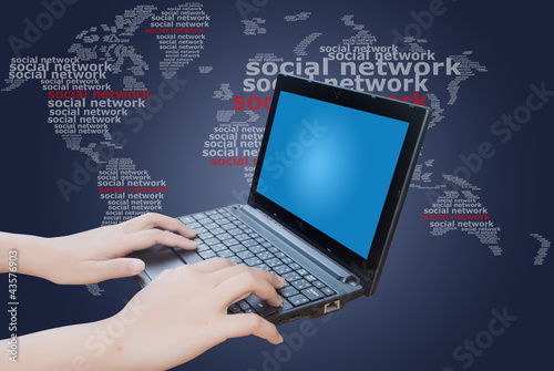 Photo: Hand pushing laptop keyboard with Social Network. Hand pushing laptop keyboard with Social Network.