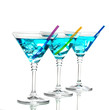 Blue cocktail in martini glasses isolated on white