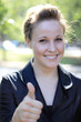 Attractive Businesswoman with Thumbs Up