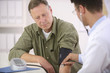 Doctor checking blood pressure