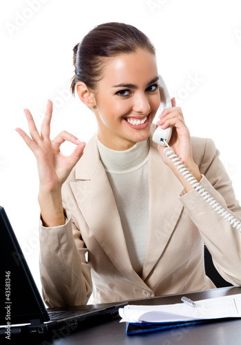 Photo: Businesswoman with phone showing thumbs up sign Businesswoman with phone showing thumbs up sign