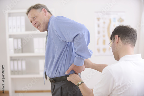 Photo: Chiropractic: Chiropractor examining senior man Chiropractic: Chiropractor examining senior man