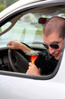 Man In Truck Holding Alcohol Looking Back At Camera