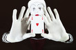 Funny mime holding a ace of hearts on black background
