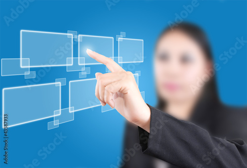 Photo: Business lady pushing button on the whiteboard. Business lady pushing button on the whiteboard.