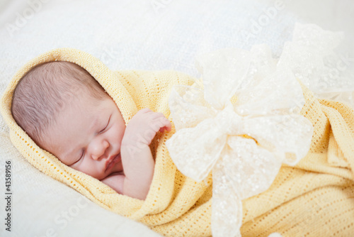 Photo: sleeping newborn baby wrapped in a yellow blanket sleeping newborn baby wrapped in a yellow blanket