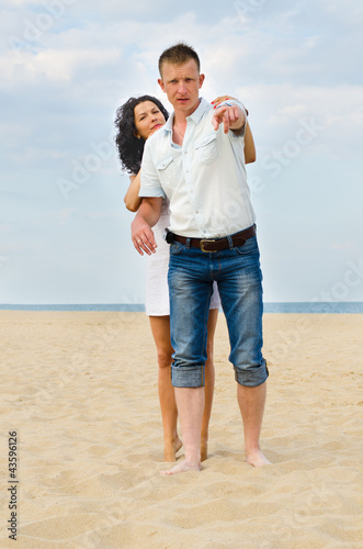 Photo: Attractive young couple on a beach Attractive young couple on a beach