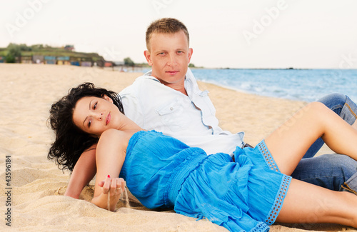 Photo: Young romantic couple on the beach Young romantic couple on the beach