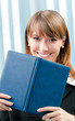 Young businesswoman with organizer at office