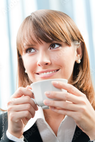 Photo: Cheerful smiling business woman with coffee Cheerful smiling business woman with coffee