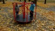 Kids approaching and starting rotation of carousel