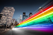 Colorful rainbow bus traffic blur in city