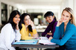 group of female college students sitting by school cafeteria