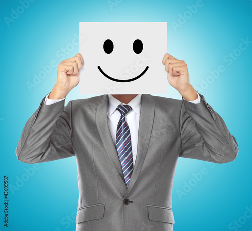 Photo: businessman with smiling mask businessman with smiling mask