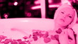 Video: a sexy beautiful woman in a large hotel bath filled with rose pe a sexy beautiful woman in a large hotel bath filled with rose pe