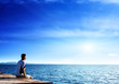 young man relax siting on pier