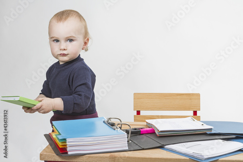 Photo: young child at writing desk young child at writing desk