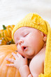 Baby sleeping on pumpkin