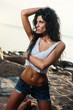 Beautiful sexy brunette woman relaxing o the beach