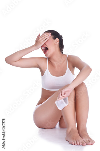 Photo: Expression woman depilating her legs Expression woman depilating her legs