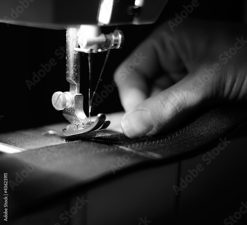 Photo: Seamstress Using Sewing Machine Seamstress Using Sewing Machine