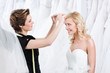 Shop assistant helps to fix the wedding tiara, white background