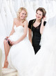 Future bride in wedding gown puts the garter on