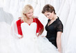 Young girl is thinking over a wedding gown