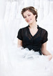 Shop assistant selects a proper dress for the client