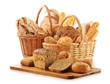 Bread and rolls in wicker baskets isolated on white
