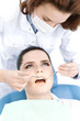 Assistant checks up the teeth of the patient