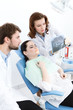 Dentist and his assistant explain details of the x ray image