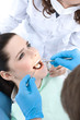 Dentist drills a carious tooth of the patient
