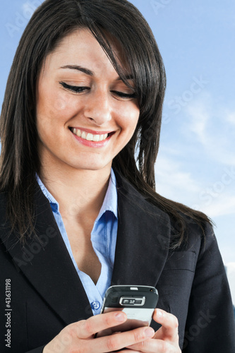 Photo: Woman using a cell phone Woman using a cell phone