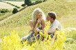 A couple sitting on the prairie chatting