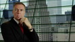 businessman thinking in front of his high rise office