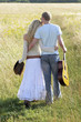 Back shot of a couple walking together on the prairie