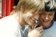 A couple listening to a telephone call together