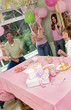 Photo: A man and woman popping out strings of paper in the air to celebrate their daughter's birthday A man and woman popping out strings of paper in the air to celebrate their daughter's birthday