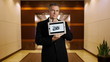 Businessman holds tablet that shows success