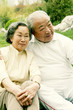 An old couple sitting together in the park