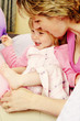 A woman looking at her daughter's foot