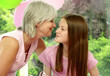 A woman giving her daughter a birthday kiss