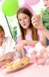 A girl pointing at the cakes