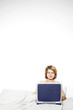 A woman sitting on the bed playing with her laptop