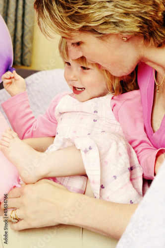 Photo: A woman looking at her daughter's foot A woman looking at her daughter's foot